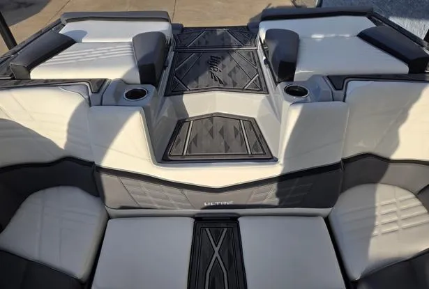 Slide: The Image of 2025 Tigé Ultré 23ZX boat interior with cushioned seating and cup holders. - 13