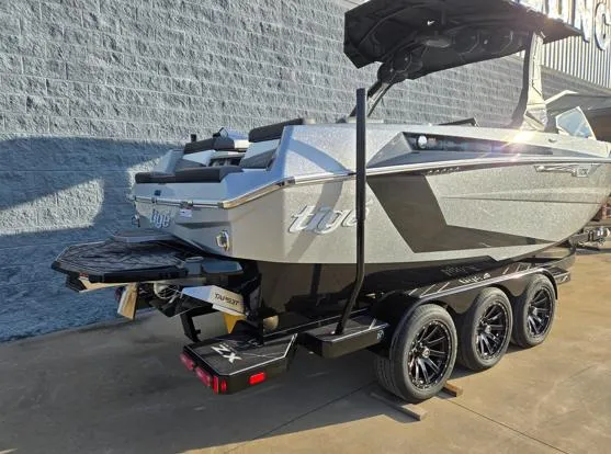 Slide: The Image of 2025 Tigé Ultré 23ZX boat on a trailer, sleek design, parked outdoors. - 20