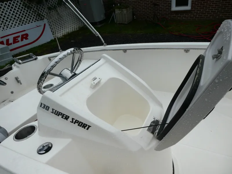 Slide: The Image of 2025 Boston Whaler 130 Super Sport boat interior with open storage compartment. - 6