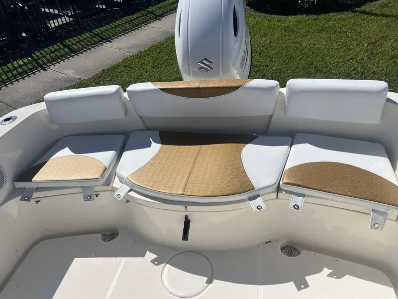 Slide: The Image of 2022 Bulls Bay 230 Center Console boat seating area with cushioned seats and backrests. - 13