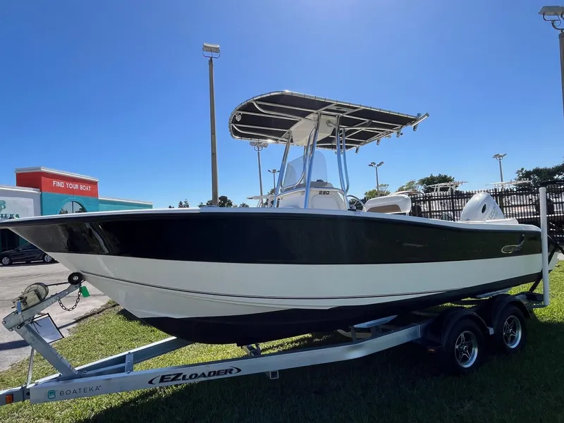 Slide: The Image of 2022 Bulls Bay 230 Center Console boat on trailer under clear blue sky. - 2