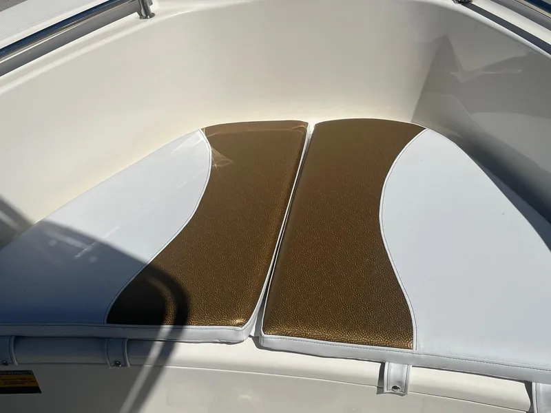 Slide: The Image of Bulls Bay 230 Center Console 2022 boat seating with brown and white cushions. - 6
