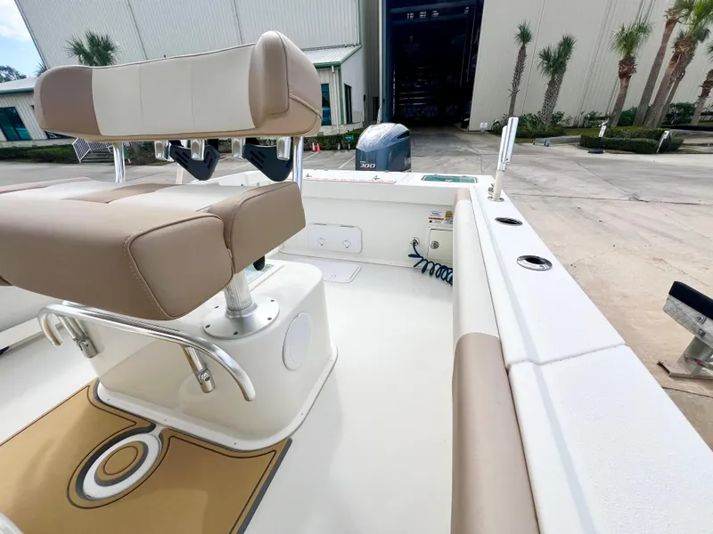 Slide: The Image of 2019 Parker 2300 Center Console boat interior with beige seating and white deck. - 12