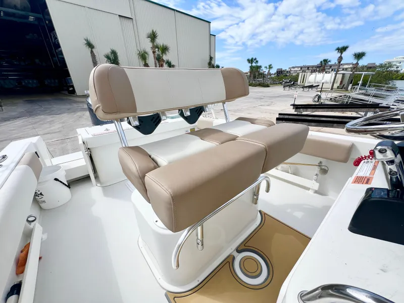 Slide: The Image of 2019 Parker 2300 Center Console boat with beige seating, docked outdoors. - 14