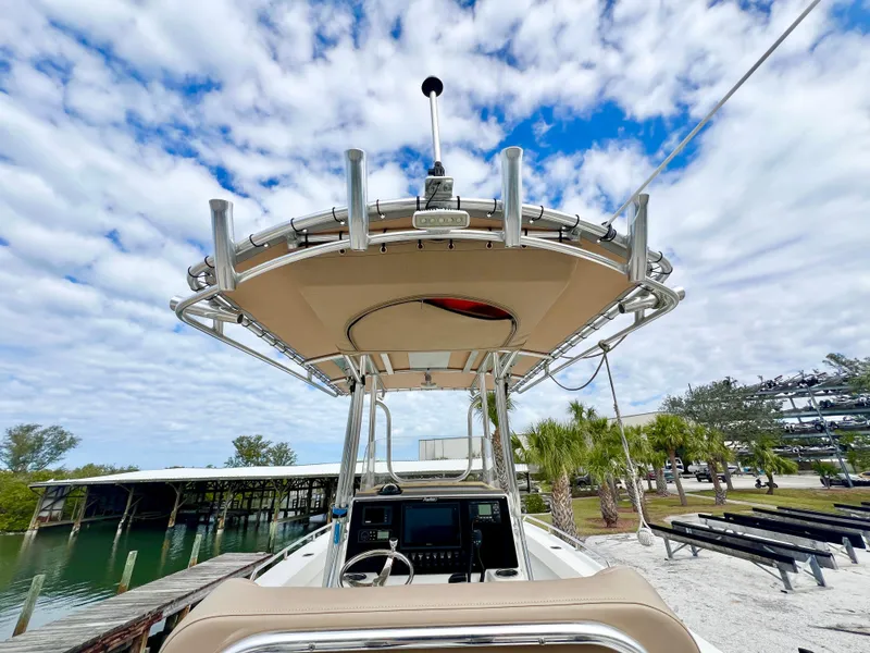 Slide: The Image of 2019 Parker 2300 Center Console boat docked under a partly cloudy sky. - 17