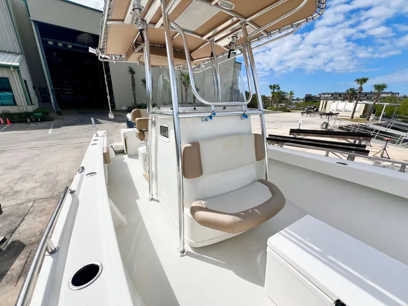 Slide: The Image of 2019 Parker 2300 Center Console boat with seating, docked outdoors under a blue sky. - 18