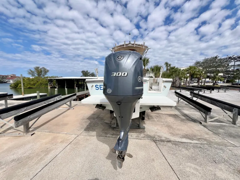 Slide: The Image of 2019 Parker 2300 Center Console boat with 300 horsepower engine on a trailer. - 2