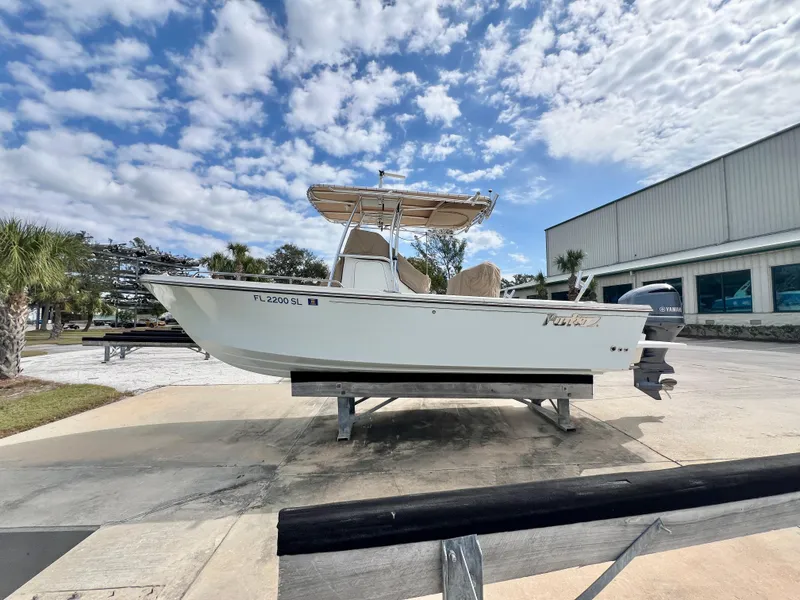 Slide: The Image of 2019 Parker 2300 Center Console boat on display under a partly cloudy sky. - 4