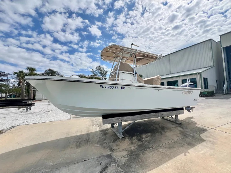 Slide: The Image of 2019 Parker 2300 Center Console boat on trailer, parked outdoors under cloudy sky. - 5