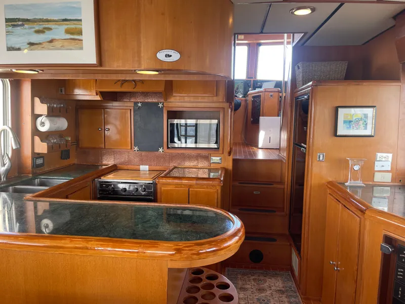 Slide: The Image of Luxurious 2002 Transpacific Marine EAGLE 53 yacht interior with modern kitchen and wooden cabinetry. - 13