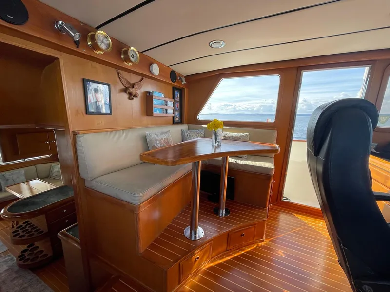 Slide: The Image of Interior of 2002 Transpacific Marine EAGLE 53 yacht with wooden dining area and ocean view. - 20