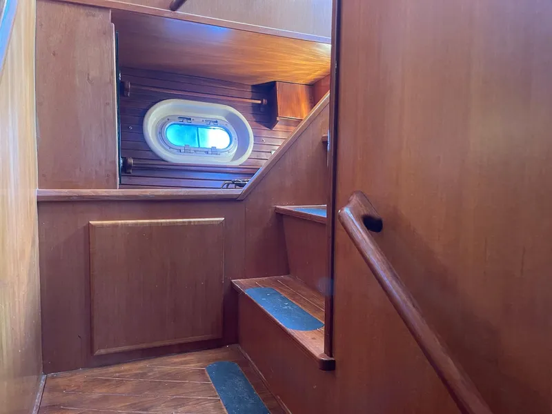 Slide: The Image of Wooden interior stairs on a 2002 Transpacific Marine EAGLE 53 yacht. - 21