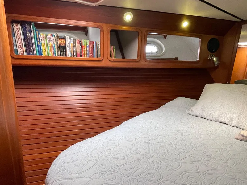 Slide: The Image of Cozy cabin interior of 2002 Transpacific Marine EAGLE 53 with books and quilted bedding. - 24