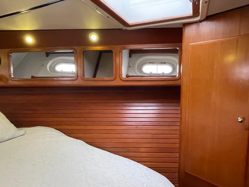 Slide: The Image of Interior cabin of 2002 Transpacific Marine EAGLE 53 yacht with wood paneling and portholes. - 25