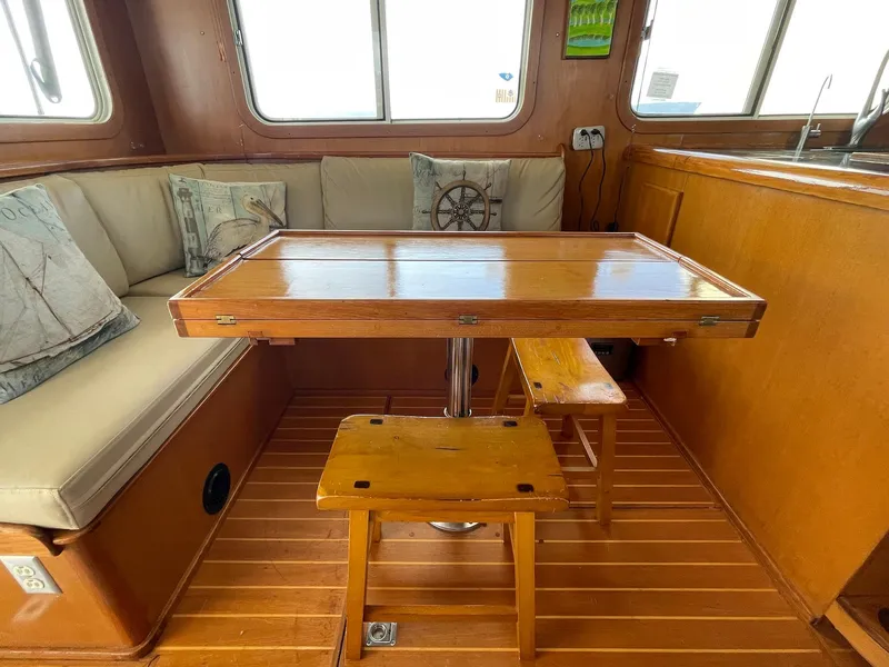 Slide: The Image of Cozy interior of 2002 Transpacific Marine EAGLE 53 with wooden table and cushioned seating. - 37