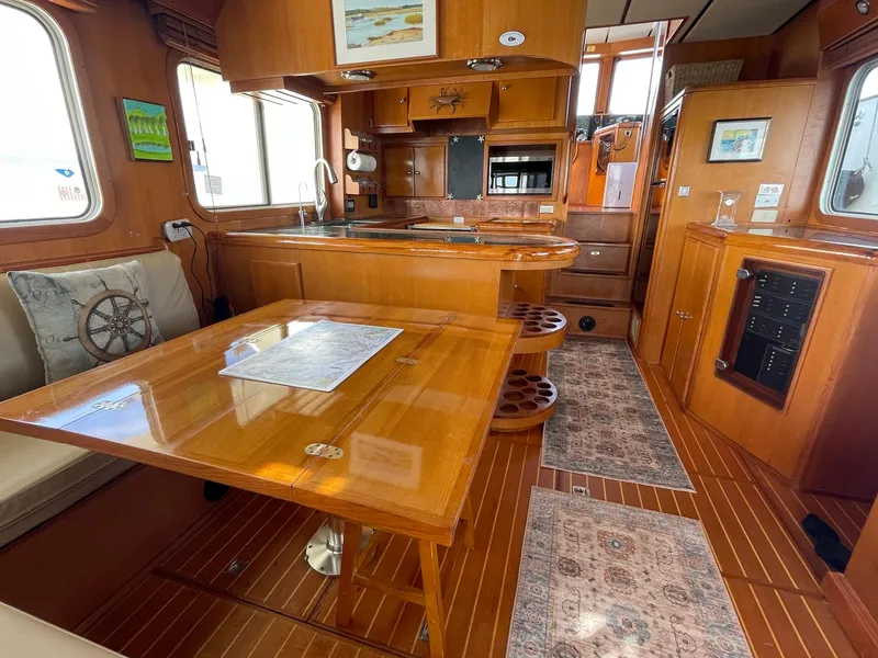 Slide: The Image of Luxurious interior of 2002 Transpacific Marine EAGLE 53 yacht with wooden furnishings and dining area. - 38
