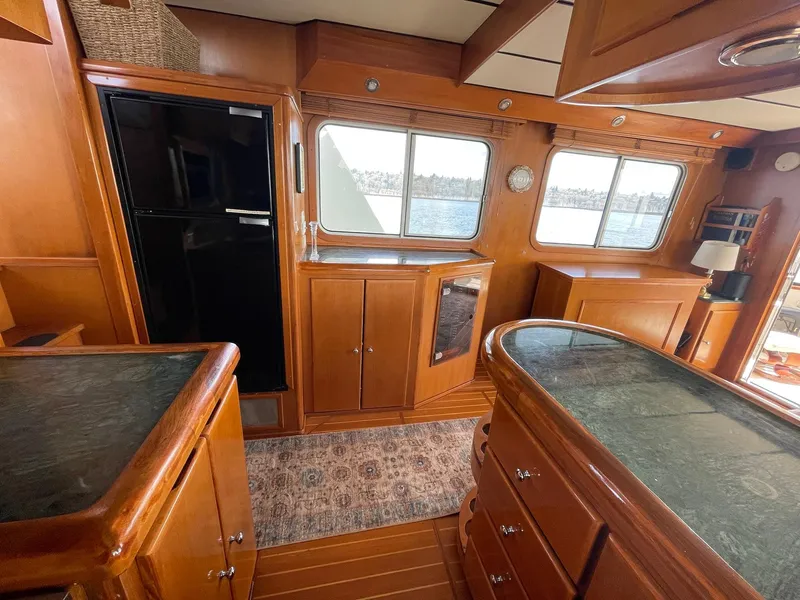 Slide: The Image of Interior of 2002 Transpacific Marine EAGLE 53 yacht with wooden cabinetry and large windows. - 40