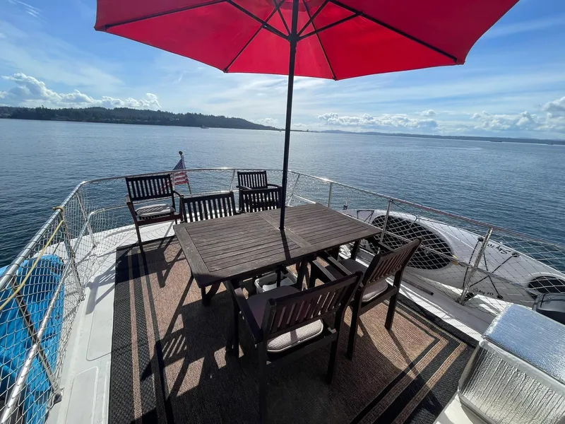 Slide: The Image of Deck of 2002 Transpacific Marine EAGLE 53 yacht with dining set and red umbrella. - 41