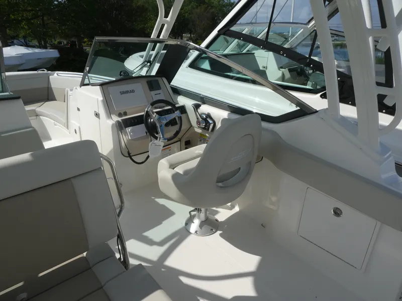 Slide: The Image of 2025 Boston Whaler 240 Vantage boat interior with steering wheel and seating. - 10