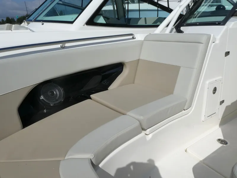 Slide: The Image of 2025 Boston Whaler 240 Vantage boat interior with beige seating and speaker. - 14