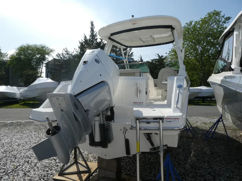 Slide: The Image of 2025 Boston Whaler 240 Vantage boat with outboard motor, displayed outdoors. - 3