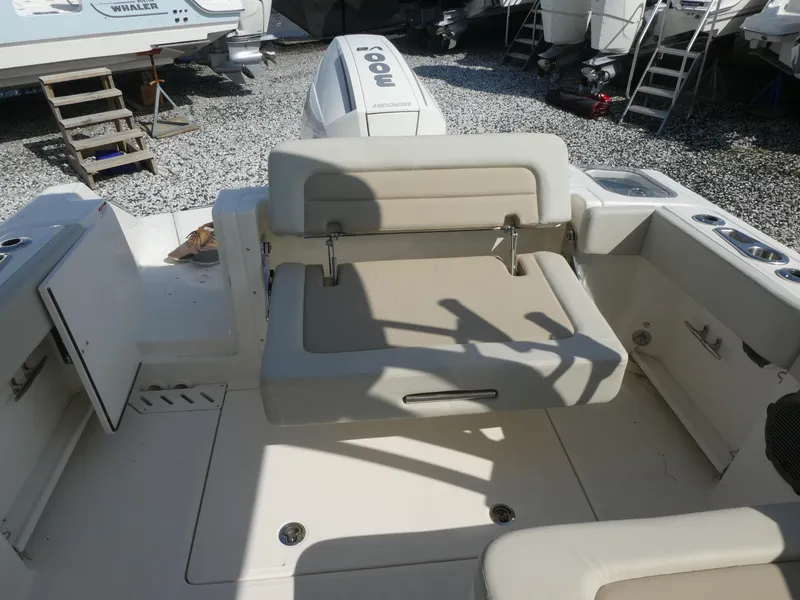 Slide: The Image of 2025 Boston Whaler 240 Vantage boat interior with seating and engine view. - 5