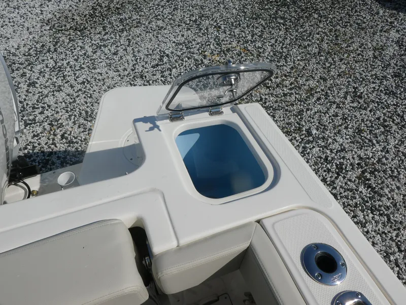 Slide: The Image of 2025 Boston Whaler 240 Vantage boat with open storage compartment on deck. - 6