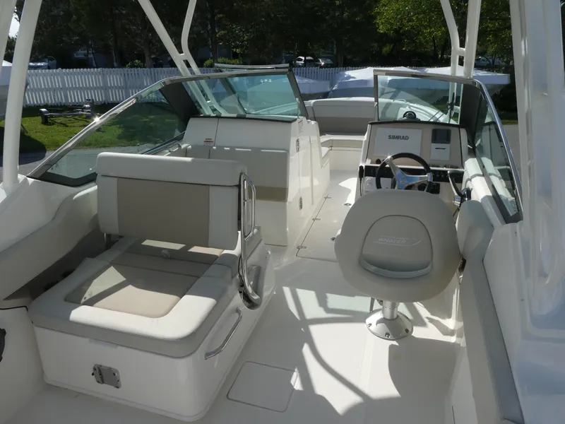 Slide: The Image of 2025 Boston Whaler 240 Vantage boat interior with seating and steering console. - 7