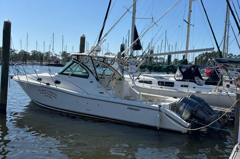 The Image of 2006 Pursuit 3370 Offshore boat docked at marina with sailboats in background. - 0