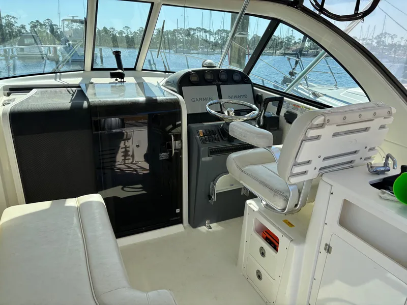 Slide: The Image of 2006 Pursuit 3370 Offshore boat cockpit with steering wheel and navigation equipment. - 14