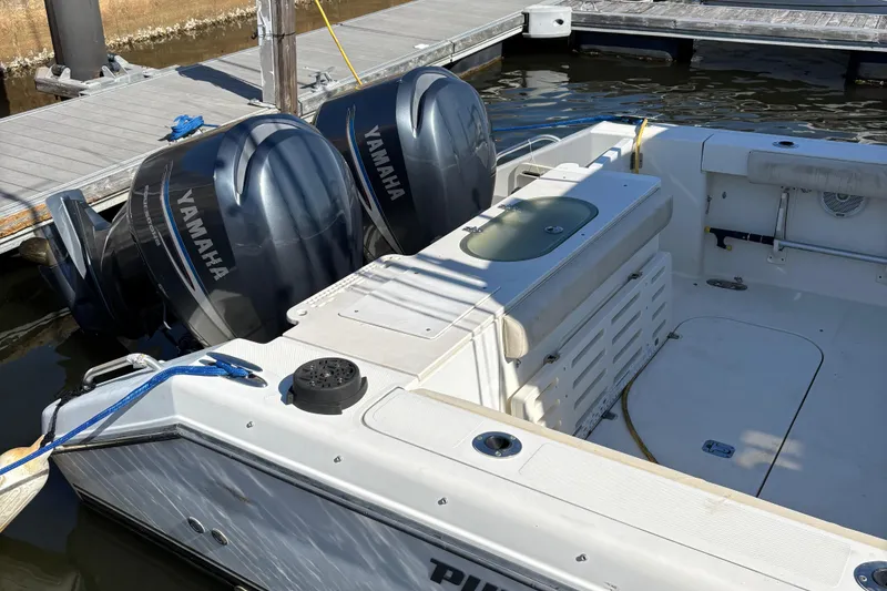 Slide: The Image of 2006 Pursuit 3370 Offshore boat with twin Yamaha engines docked at marina. - 18