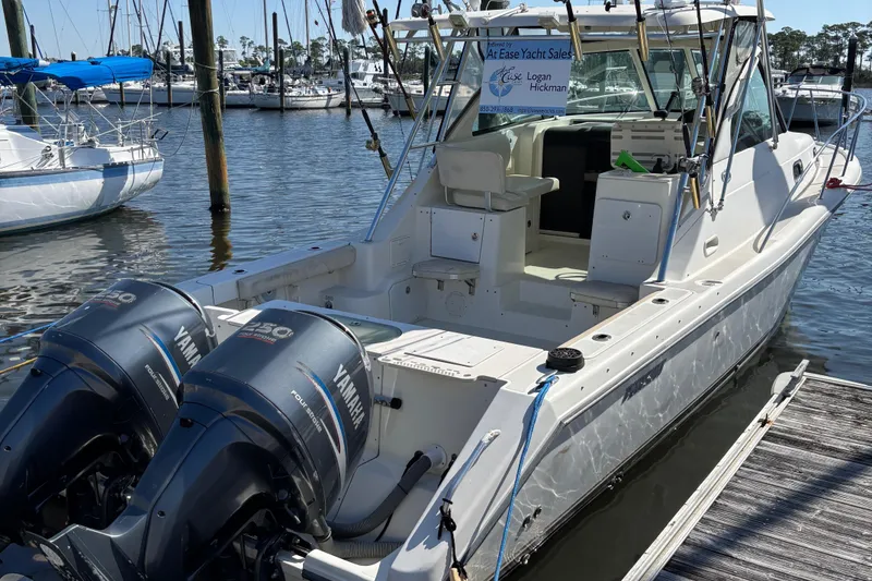 Slide: The Image of 2006 Pursuit 3370 Offshore boat docked with twin Yamaha engines in a marina. - 19