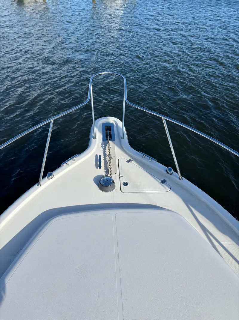 Slide: The Image of Bow view of 2006 Pursuit 3370 Offshore boat on water. - 4