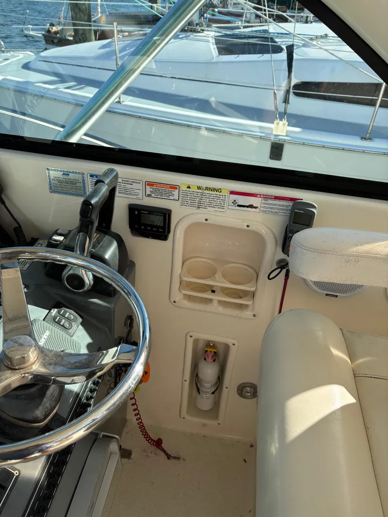 Slide: The Image of 2006 Pursuit 3370 Offshore boat helm with steering wheel and control panel. - 7