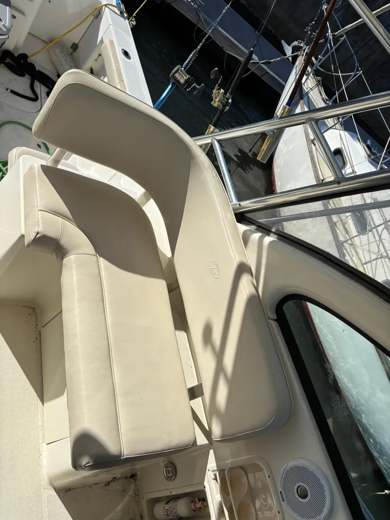 Slide: The Image of 2006 Pursuit 3370 Offshore boat interior with seating and fishing rods. - 8
