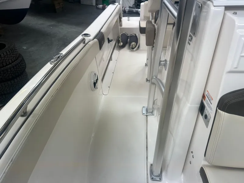 Slide: The Image of 2019 Robalo R222 Center Console boat interior with seating and railings. - 11