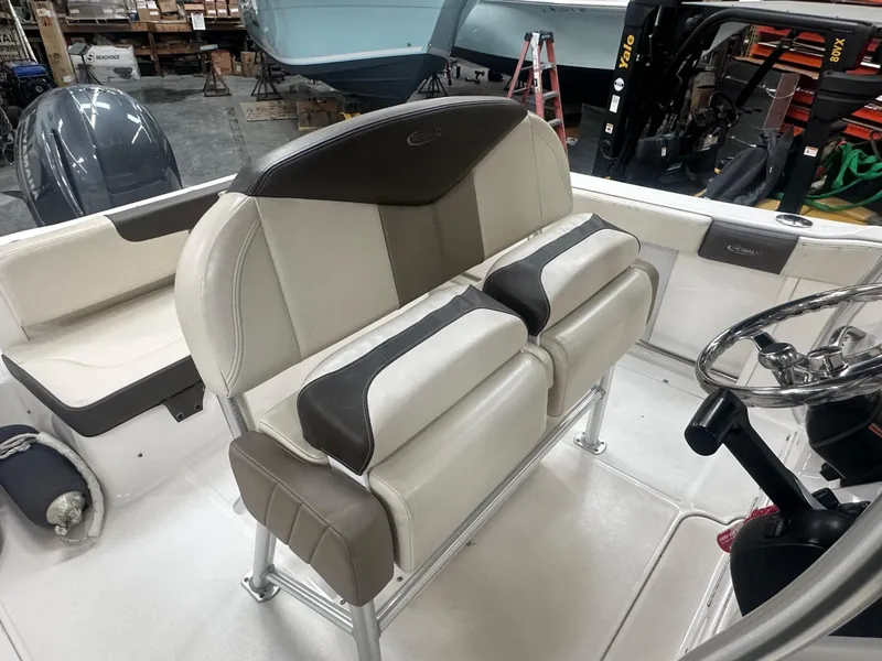 Slide: The Image of 2019 Robalo R222 Center Console boat interior with cushioned seating and steering wheel. - 13