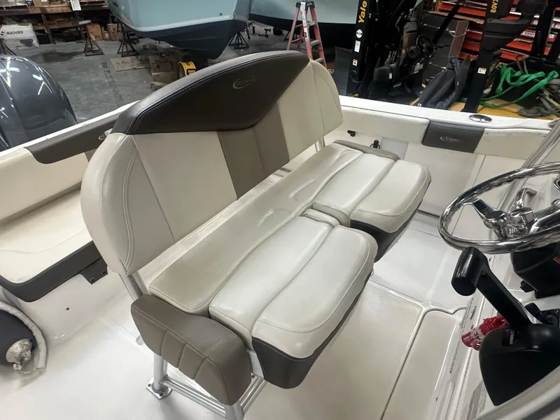 Slide: The Image of 2019 Robalo R222 Center Console boat interior with cushioned seating and steering wheel. - 15