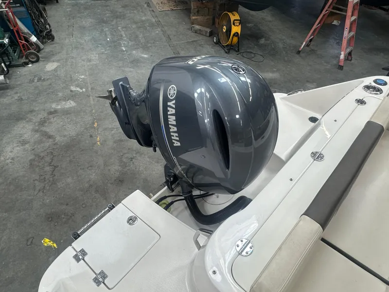 Slide: The Image of 2019 Robalo R222 Center Console with Yamaha outboard motor in a garage setting. - 18