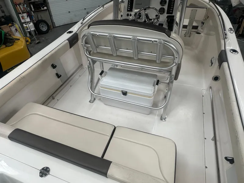 Slide: The Image of 2019 Robalo R222 Center Console boat interior with seating and storage. - 19