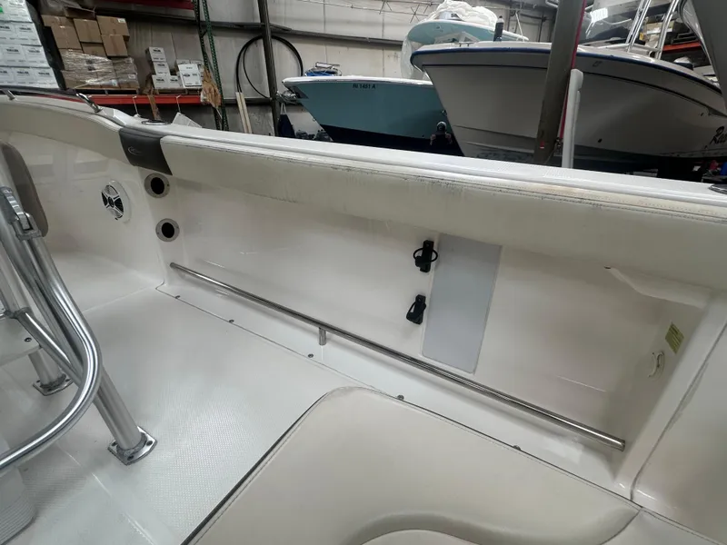 Slide: The Image of 2019 Robalo R222 Center Console interior, showcasing seating and storage features in a showroom. - 20