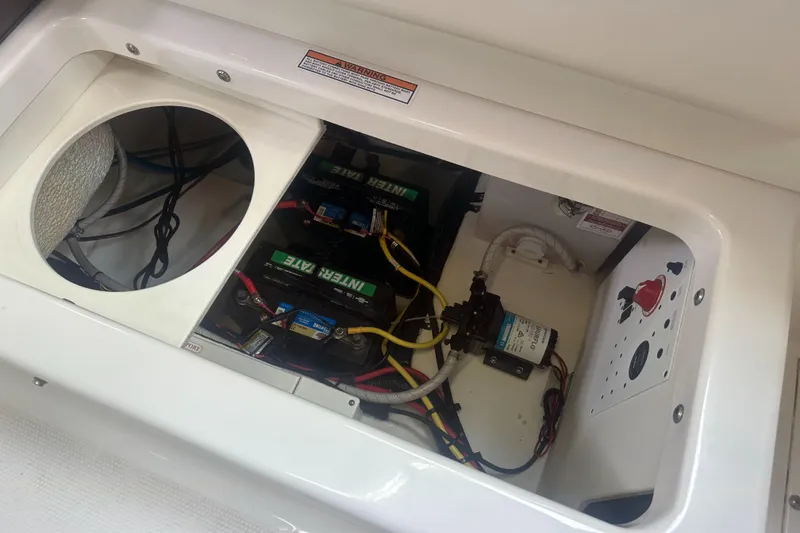 Slide: The Image of 2019 Robalo R222 Center Console battery compartment with wiring and components. - 22
