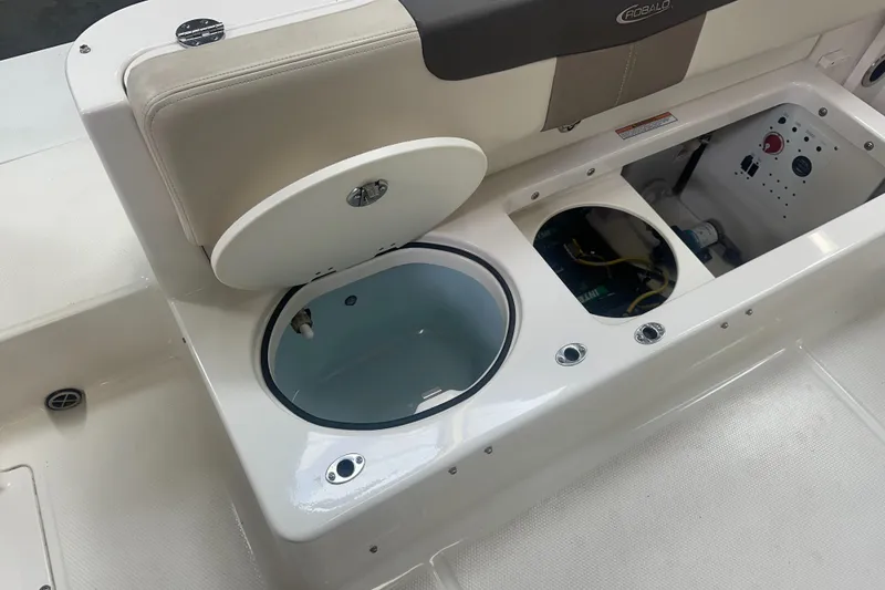 Slide: The Image of 2019 Robalo R222 Center Console boat with open storage compartments and seating. - 23