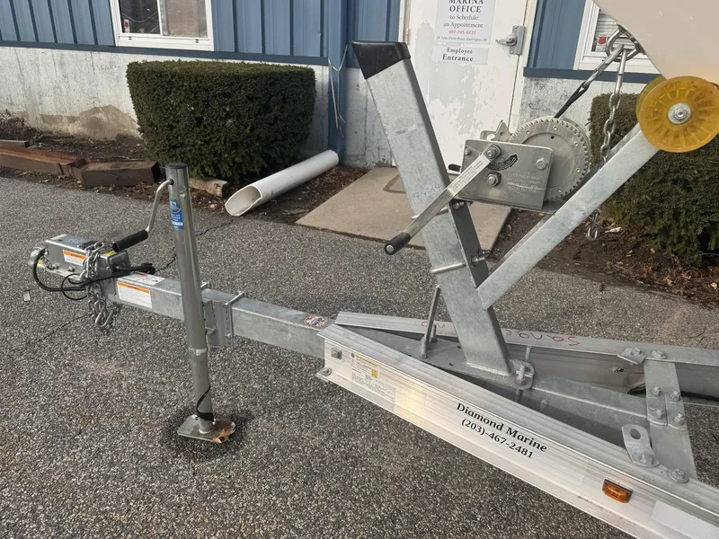 Slide: The Image of Trailer for 2019 Robalo R222 Center Console boat parked on asphalt near a building. - 27