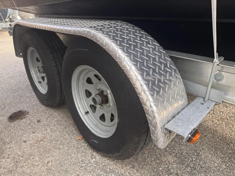Slide: The Image of Trailer wheels and fender of a 2019 Robalo R222 Center Console boat. - 30