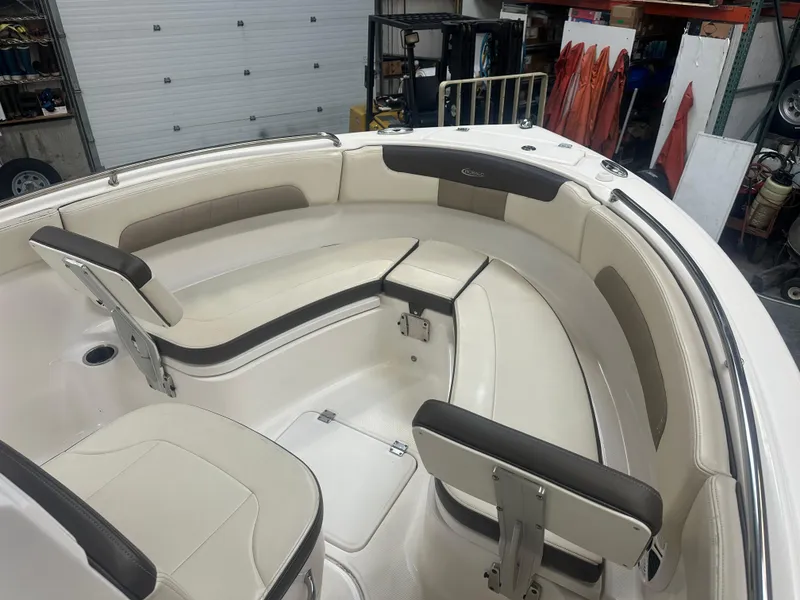 Slide: The Image of 2019 Robalo R222 Center Console boat interior with cushioned seating and storage compartments. - 5