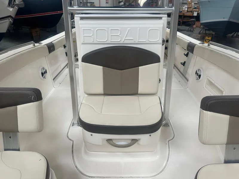 Slide: The Image of 2019 Robalo R222 Center Console boat interior with cushioned seating and branded backrest. - 8