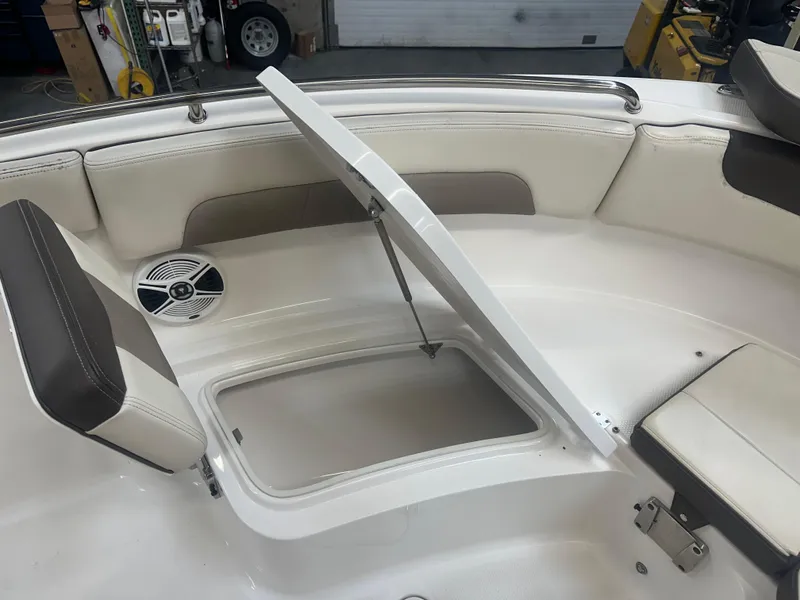 Slide: The Image of 2019 Robalo R222 Center Console boat with open storage compartment and seating. - 9