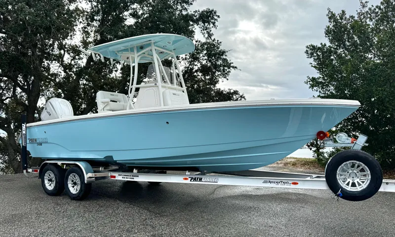 Slide: The Image of 2025 Pathfinder 2400TRS boat on trailer, light blue hull, parked outdoors. - 1
