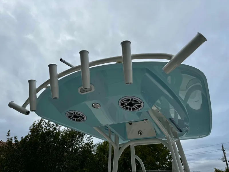 Slide: The Image of T-top of 2025 Pathfinder 2400TRS boat with rod holders and speakers. - 10